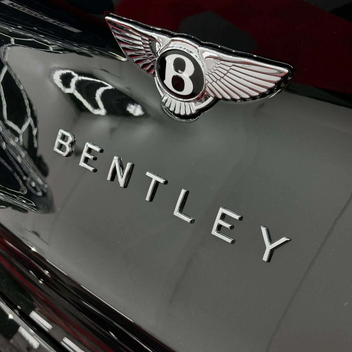 Close up of Bentley car badge on back of car